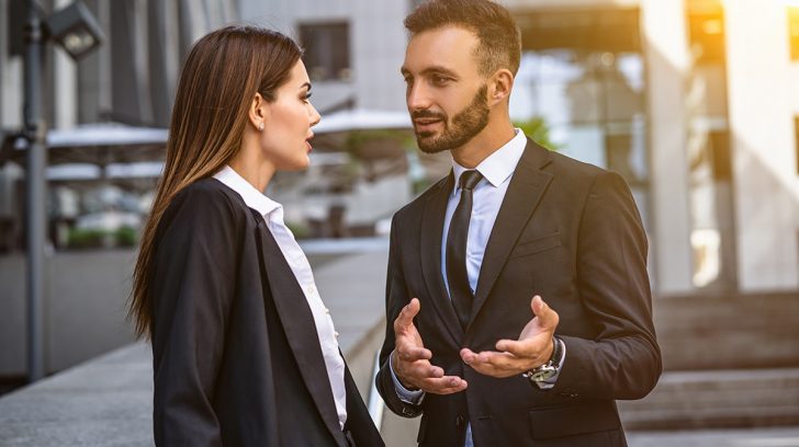 The business man and woman standing on the urban background